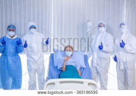 Old Woman Patient Hold Mini Heart On A Wheelchair With Background Of The Medical Team Thumbs Up Afte