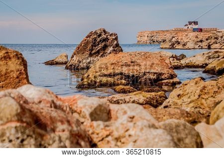 Black Sea Red Rocks Coastline. Cape Chersonesos Wild Beach In Sevastopol, Crimea