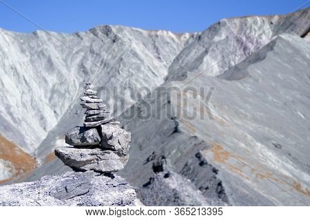 Pyramid Of Stones In The Open Air, Different Sizes, View Of The Mountain. A Pyramid Of Large Stones 
