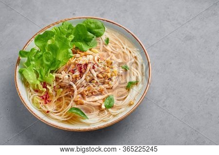 Guay Tiew Gai Cheek Or Thai Chicken Noodle Soup In White Bowl On Gray Concrete Backdrop. Guay Tiew G