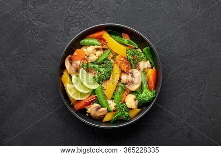 Pad Pak Ruam Or Veg Thai Stir-fried Vegetables In Black Bowl On Dark Slate Backdrop. Pad Pak Is Thai