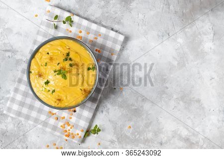 Vegeratian Red Lentil Creamy Soup With Pumpkin And Potatoes Decorated With Marjoram In A Bowl On A G