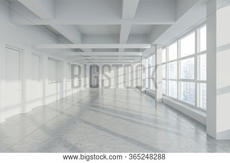 Interior Of Empty Panoramic Industrial Style Office With White Walls, Concrete Floor, Row Of Lamps, 