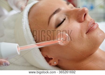Female Receiving Galvanic Facial Treatment In Spa Cosmetologist Professional Services.