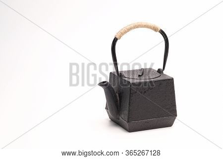 Black Metal Cast-iron Traditional Teapot On White Background.