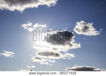 Beautiful Clouds In The Sky. Clouds In The Blue Sky With A Sun Light. A Miracle Gods Light Against B