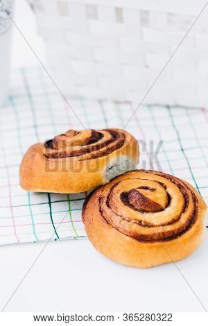 A Cinnamon Bun On A Napkin On White