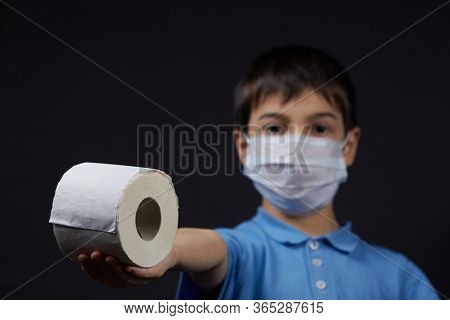 A Child In A Protective Mask Holding Toilet Paper Napkins