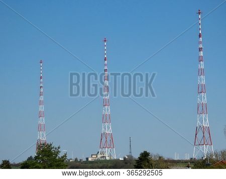 Junglinster Longwave Transmitter - Three 215 M Tall Metal Framework Towers, White And Red Against Bl
