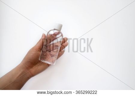Jar With Antiseptic Gel In A Hand On A White Background. Antimicrobial Cleanser. Composed Of Alcohol