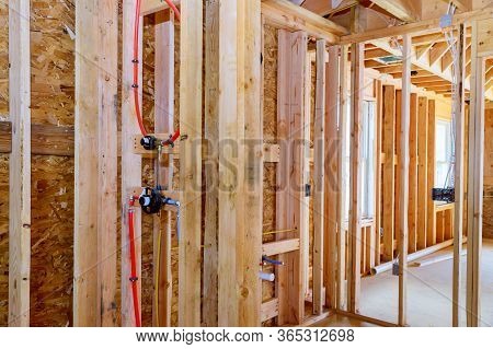 Home Construction With Hot Red And Cold Blue Pex Pipe Layout In Pipes And Exposed Beams