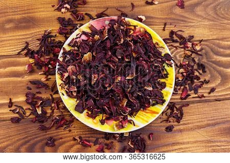 Dried Hibiscus (carcade, Roselle) On Wooden Table