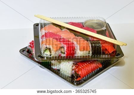 Sushi Rolls Pack In Plastic Container On White Background.