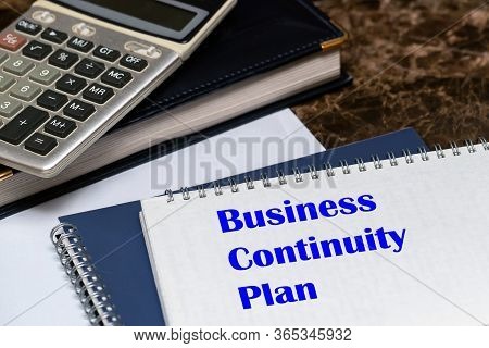The Text Of The Business Continuity Plan Is Written On A White Sheet Lying On The Office Desk. Conce
