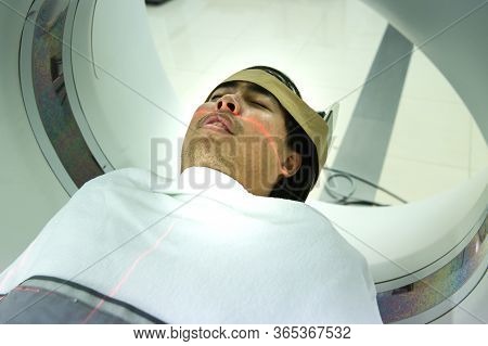 Patients Screening On Ct Scanner. Man Undergoing Ct Scan While Doctor\'s Using Computers. Examining 