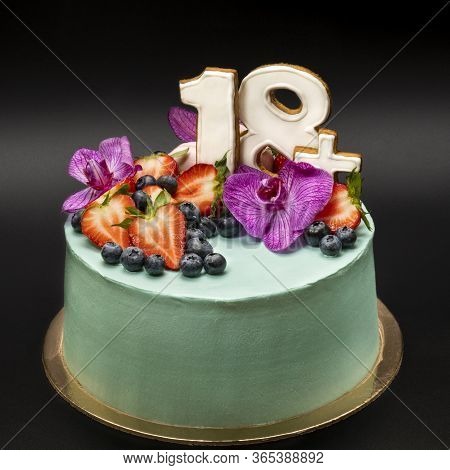 Turquoise Fruit Cake With Numbers 18plus With Strawberries, Blueberries And Orchid Flowers. Closeup