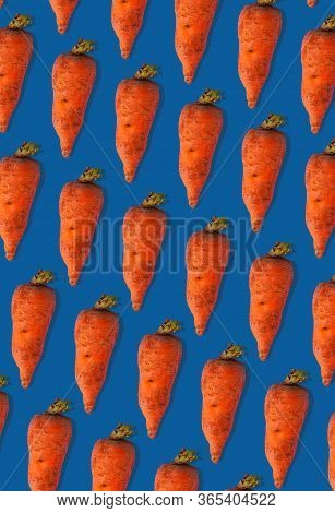 Ugly Carrots Regular Pattern With Shadows Pastel Background. Big Deformed Vegetables On Pastel Backg