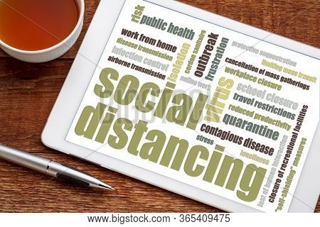 Social distancing word cloud on tablet - a set of nonpharmaceutical infection control actions to stop or slow down the spread of a contagious disease. Coronavirus covid-19 pandemic concept.