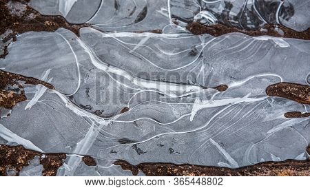 Ice Surface On A Frozen Puddle. Ice Texture Close Up. Amazing And Beautiful Abstract Drawing Of Froz
