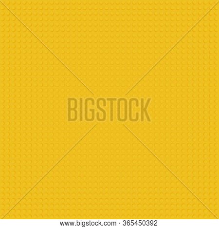 Yellow Base Template Of Plastic Construction Brick. Plastic Toy Blocks Background In Yellow. Constru