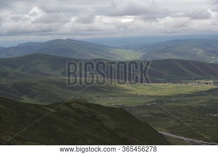 Overlooking The Valley Of Qilian Mountains Prairie Covered By Dark Clouds