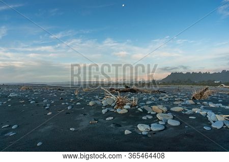 Beach Landscape With Black Volcanic Sand And Pebbles, Rocks. Okarito Beach With Black Sand. New Zeal