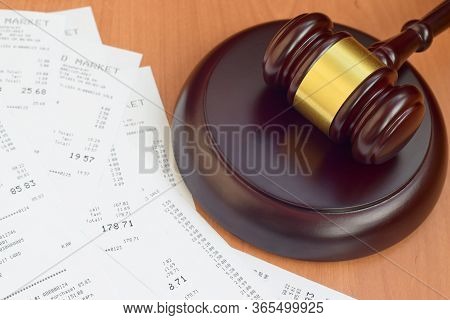 Justice Mallet And Many Supermarket Receipts On Wooden Table