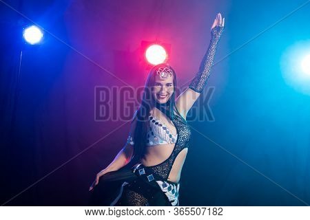 Girl Dancing Belly Dance, Fusion Or Tribal. A Woman In A Beautiful Costume Demonstrates Charming And
