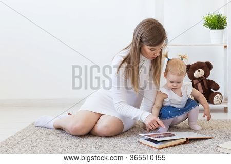 Hearing Aid In Baby Girls Ear. Toddler Child Wearing A Hearing Aid At Home. Disabled Child, Disabili