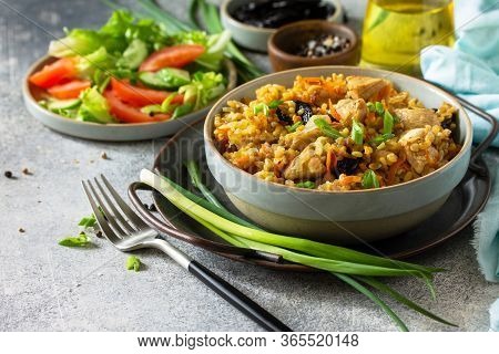 Bulgur Pilaf. Healthy Eating Concept. Bulgur With Chicken, Vegetables And Prunes On A Gray Stone Or