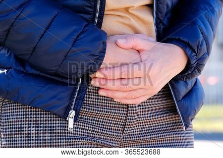 The Girl On The Street Felt A Twinge Of Pain In Her Stomach. Holding On With Both Hands To The Sore 