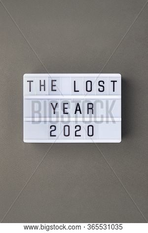 Falling Growth In Business, Composition With Lightbox With The Lost Year 2020 Slogan On Grey Paper B