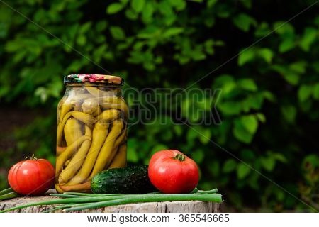 Canned Pickled Chili Peppers In A Glass Jar