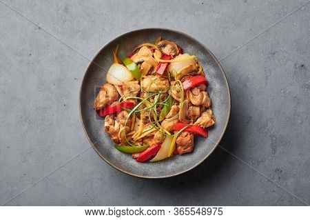 Thai Ginger Chicken Or Gai Pad King In Gray Matte Bowl On Concrete Backdrop. Gai Pad King Is Thailan