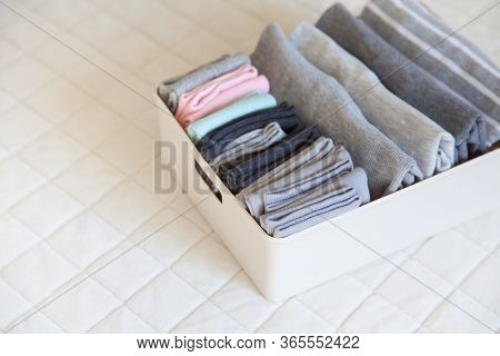 Box With Brught Socks, Closeup. Sort Up Socks. White Background. Basket.