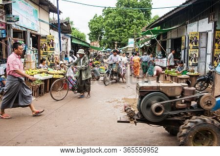 Myanmar - October 29 2013; Muddy Street Through Typical Busy Village Market With Stalls, Vendors And
