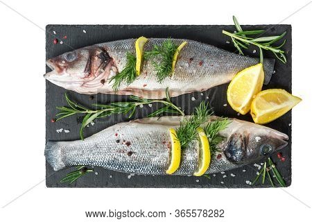 Fresh Fish Seabass And Ingredients For Cooking. Raw Gutted Fish Seabass With Spices And Herbs On Bla