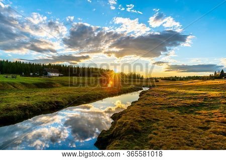 Rural Grassland Landscape In Sunny Spring Evening. Sunset In Jizerka Village With Jizerka River, Jiz