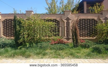 Decorative Lawn In Front Of A Decorative Brick Fence