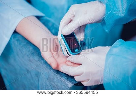 Pulse Oximeter On The Patients Hand. Surgery Equipment.