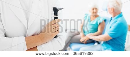 Diagnosis And Treatment Of Hearing. Doctor With An Otoscope, Hearing Test, Diagnosis Of Ear Diseases