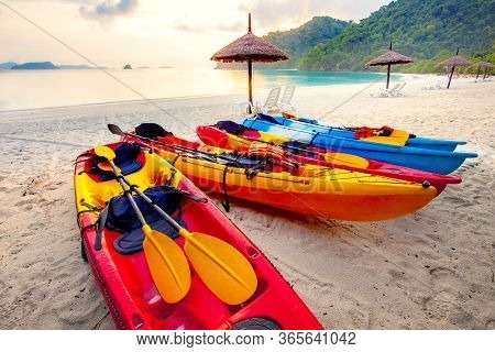 Stack Of Sea Kayak On Beautiful Sand Beach Against Morning Usn Rising