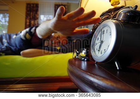 Morning Wake Up In The Bedroom. The Man Sleep And Turns The Alarm Off With His Hand. Early Clock Tim