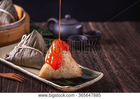 Zongzi - Chinese Rice Dumpling Zongzi In A Steamer On Wooden Table Black Retro Background For Dragon