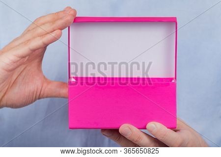 Open Pink Box In The Men's Hands. Front View. Close Up. Copy Space. Moke Up.