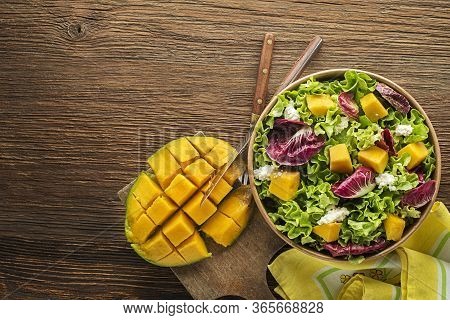 Healthy Lettuce Salad With Mango Fruit And Fresh Cheese On Wooden Table Background. Healthy Salad Me