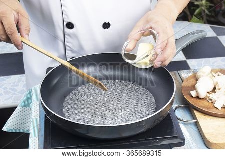 Chef Putting Butter In The Pan Prepared For Cooking Mushroom Cream Soup / Cooking Mushroom Cream Sou