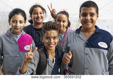 Mahdia, Tunisia - 03 October, 2019: A Group Of Five Arab Schoolchildren Are Looking At The Camera Ch