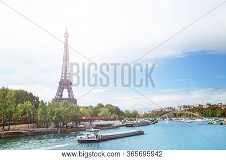 View Over Seine River On Eifel Tower With Boats Passing And Passerelle Debilly During Summer, Paris 