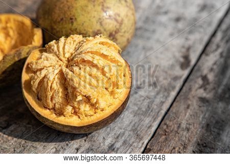 Exotic Indian Bel Fruit Or Wooden Apple. Bel Fruit Slices On Wooden Rustic Background. Natural Detox